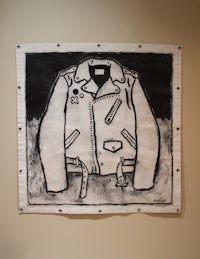 a black and white drawing of a jacket hanging on a wall